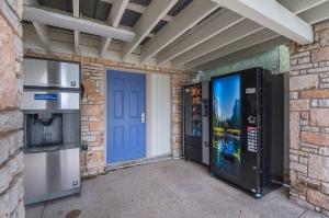 a garage with a blue door and a television and a vending machine at Motel 6-Boerne, TX in Boerne