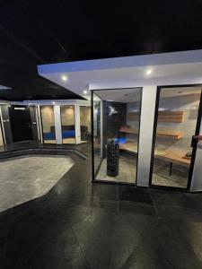 a room with glass doors and a building at Bed & Wellness Malina deluxe in Lelystad