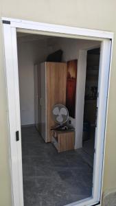 a room with a door open to a room with a mirror at House in garden in Nea Kalikratia