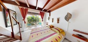 a bedroom with a bed in a room with a window at L'Oasis de L'Anse Bleue in Le Diamant +121 photos
