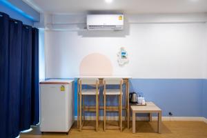 a kitchen with a small table and a refrigerator at PanoSea Bangsaen in Ban Bang Saen (1)