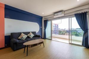 a living room with a couch and a table at PanoSea Bangsaen in Ban Bang Saen (1)