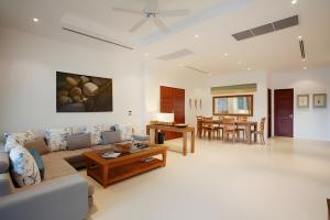 a living room with a couch and a table at 3BR SeaView Villa with Private Pool Kamala Falls in Kamala Beach