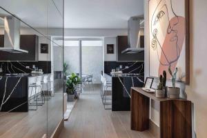 a kitchen with black countertops and a dining room at ®{LUX~City~Skyline} @DowntownSD PrivéJaccuziGym in La Julia