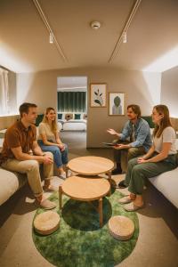 a group of people sitting in a room at R Residence 天下茶屋 IV in Osaka