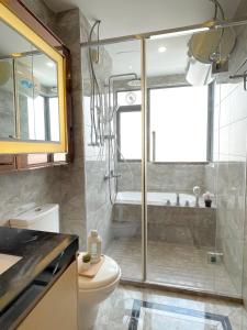 a bathroom with a shower and a toilet at R&F SeaView Rare Bathtub 3BR Hotel Feel 4-10pax in Iskandar Puteri