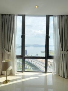 a room with a large window with a view at R&F SeaView Rare Bathtub 3BR Hotel Feel 4-10pax in Iskandar Puteri