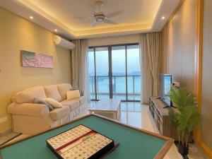 a living room with a couch and a pool table at R&F SeaView Rare Bathtub 3BR Hotel Feel 4-10pax in Iskandar Puteri