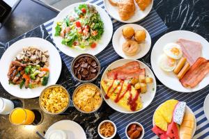 un mucchio di piatti di cibo su un tavolo di Ramada By Wyndham Bangkok Sukhumvit 87 a Bangkok