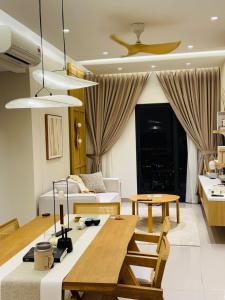 a living room with a table and a couch at KL Desa Park City Muji Suite in Kuala Lumpur