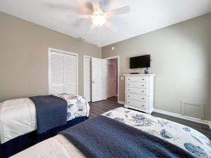 a bedroom with two beds and a ceiling fan at Canterbury Court - 6A in Myrtle Beach +39 photos