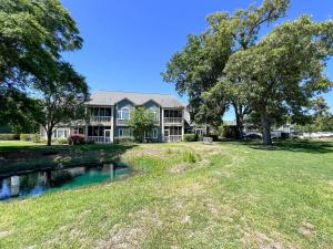 a large house with a pond in the yard at Canterbury Court - 6A in Myrtle Beach