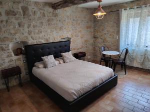 a bedroom with a bed and a table and chairs at VILLA ARTEMIA - chambre d hôtes labellisée massages-piscine-climatisation in Sigean +62 photos