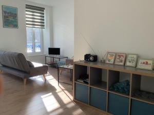 a living room with a couch a chair and a table at Port Rhu Appartement 4 personnes in Douarnenez