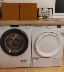 a washing machine with a box on top of it at Port Rhu Appartement 4 personnes in Douarnenez +8 photos