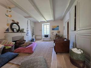 a living room with a couch and a chair at 751 - Maison de caractère avec magnifique jardin clos in Erquy