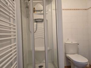 a bathroom with a toilet and a glass shower at 751 - Maison de caractère avec magnifique jardin clos in Erquy +16 photos