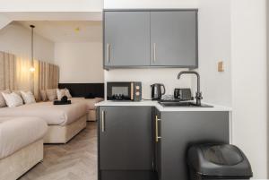 a kitchen and living room with a couch and a microwave at Bold St City Centre Freewifi Walk Everywhere in Liverpool