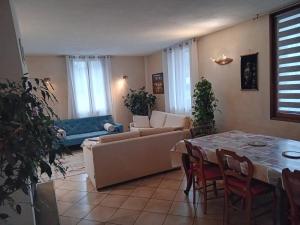 a living room with a couch and a table at La Vie en Rose et Azur in Cluses +3 photos