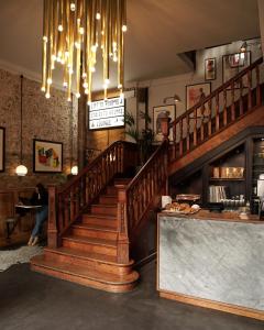 a staircase in a restaurant with a chandelier at The Pilgrm in London