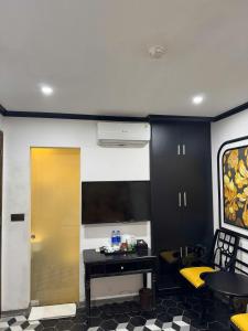 a room with a yellow door and a table and chairs at Golden Hotel in Hanoi