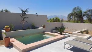 a swimming pool in the middle of a patio at The Royal Hilltop in Riebeek-Kasteel