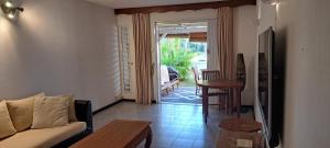 a living room with a couch and a table at Kenville in Cap Malheureux