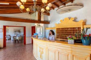 Una mujer hablando por celular en un bar en Li Suari Club Village, en San Teodoro 153 fotos más