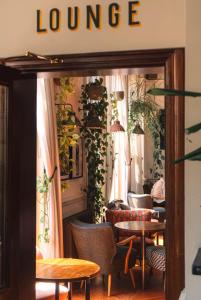 a room with tables and chairs and a mirror at The Pilgrm in London
