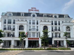a large white building with a sign on it at Royal Louis Hotel in Hanoi