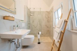 a bathroom with a sink and a toilet and a shower at Ferienwohnungen St Marien in Gengenbach +88 photos