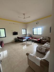a large living room with couches and a tv at 2BHK Nature Stay in Wādhiware
