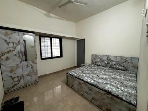 a bedroom with a bed in a room with a window at 2BHK Nature Stay in Wādhiware