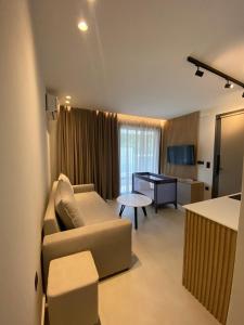 a living room with a couch and a table at Sealuxe Living in Iraklitsa