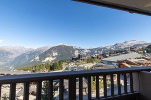 a view of the mountains from a balcony at La Foret du Praz 501 in Courchevel