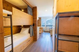 a small room with bunk beds in a cabin at La Foret du Praz 501 in Courchevel