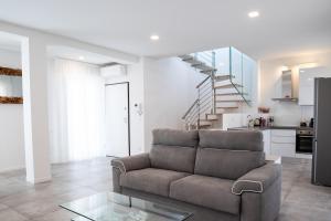 a living room with a couch and a staircase at The Rooftop in Bologna