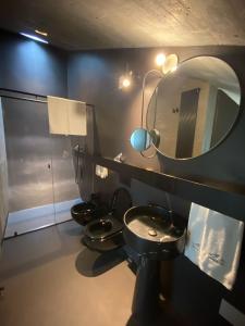 a bathroom with three toilets and a mirror at Cantina dei 5 Sogni in Monforte dʼAlba