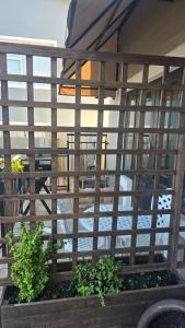 a view of a building through a fence with plants at Accommodation Unwind in Langebaan +1 photo