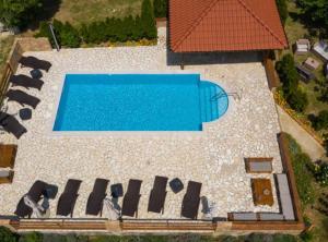 an overhead view of a swimming pool with chairs around it at Apartments Scerbe Gordana & Miljenko Rab in Otok Rab +55 photos