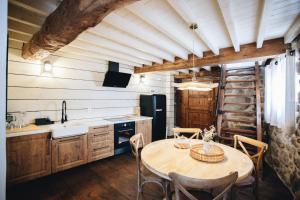 a kitchen with a table with chairs and a refrigerator at Casa da Edrada  +28 photos