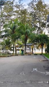 a parking lot with palm trees in a park at MZS Studio Swiss Garden R in Kuantan +9 photos