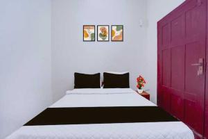 a bedroom with a large bed with a red door at Hotel O Kallar Vattiyar Waterfalls Munnar in Munnar
