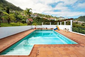 a swimming pool on the roof of a house at Traveller's House in Ribeira Seca