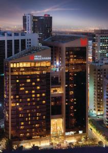 a view of a large building in a city at night at Grand Millennium Dubai in Dubai