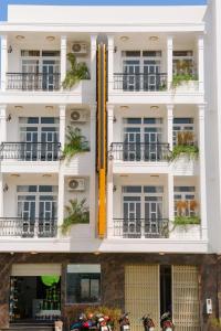 a white building with motorcycles parked in front of it at Hoa Hướng Dương Hotel in Phan Rang
