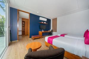 a hotel room with a bed and a chair at Phuket La Siesta Pool Villas & Pool Access Rooms in Nai Harn Beach