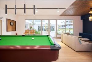 a living room with a pool table and a couch at Big 1 Bedroom Apartment at Cantonments - Pool, Gym, Game Room in Accra