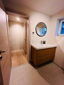 a bathroom with a sink and a mirror at Lodge Rose's Heart in Bramberg am Wildkogel +102 photos