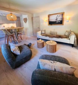 a living room with two couches and a table at Lodge Rose's Heart in Bramberg am Wildkogel